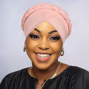 Close-up of pink braided turban hat showing soft elastic fabric texture and twist detail