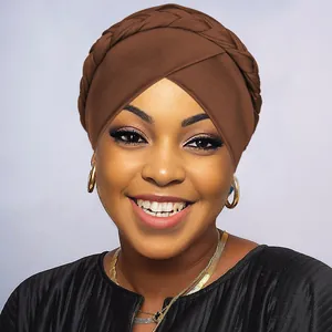 Detail view of brown braided turban headwrap showing textured cross-weave and fabric layers