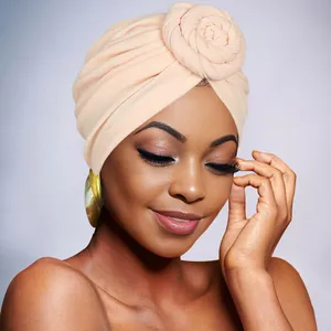 Detail of rose-colored bohemian turban hat with 3D floral knot decoration for women