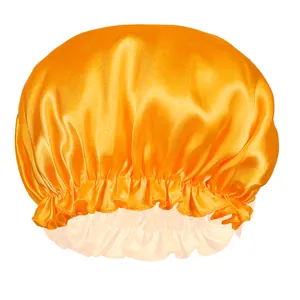 Detail of orange satin sleep cap showing elastic lace trim and silky texture