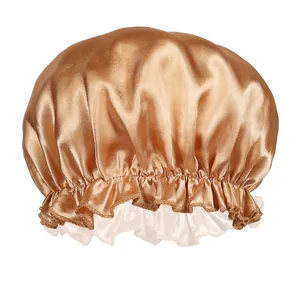 Detail of golden brown satin sleep cap showing the elastic band and white lace trim