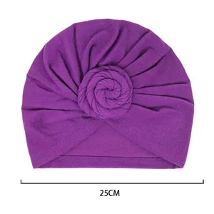 Deep purple pleated turban hat with spiral flower knot and 25cm width measurement