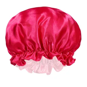 Detailed view of dark red satin sleep cap with elastic ruffled edge on white background