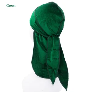 Detailed close-up of dark green velvet durag with long tail and fine stitching on a mannequin