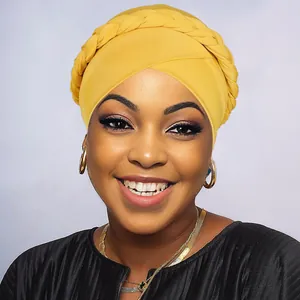Close-up of bright yellow braided turban hat with intricate twist knot detailing