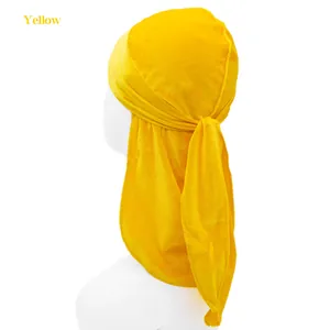 Detail view of the long tail tie and velvet texture on the yellow kids durag