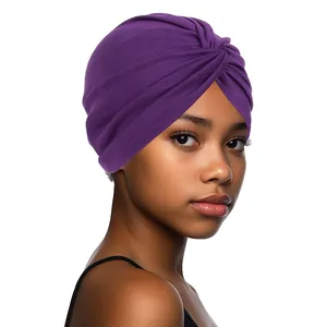 Detailed macro view of the purple twisted knot and soft fabric texture on the turban hat