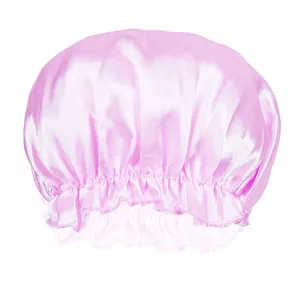 Detail of pink satin sleep cap featuring soft elastic lace trim and glossy silk texture