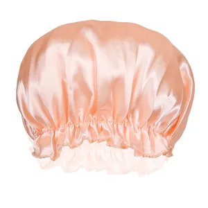 Detail view of champagne satin hair bonnet showing smooth texture and ruffled elastic band