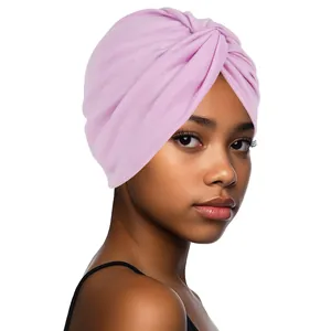 Detail of the twisted pleat design and soft knit texture on a pale pink turban headwrap