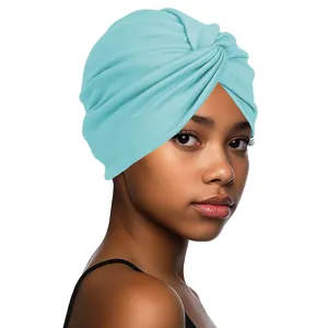 Detail of light blue turban cap with cross twist design and soft knit texture
