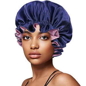 Detail of double-layer satin bonnet with ruffle edge in navy blue and pink silk