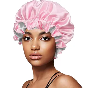 Close-up of double-layered satin bonnet with elastic band and ruffled pink texture