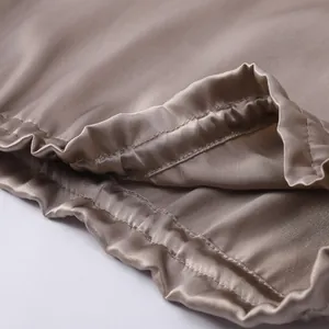 Champagne satin bonnet with elastic band and double-row stitching details