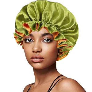 Detail of green and orange reversible satin sleep cap with ruffled elastic band edges