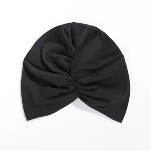 Women's black stretch knit turban hat featuring a classic twisted cross front design