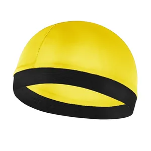 Detail of children's dome cap featuring yellow top and black elastic contrast band