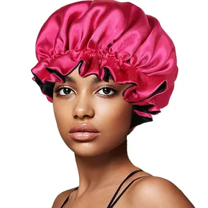 Close-up of rose red satin sleep cap with elastic ruffled edge and black lining on model