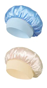 Detail of satin sleep caps with rhinestones and wide elastic bands in light blue and beige