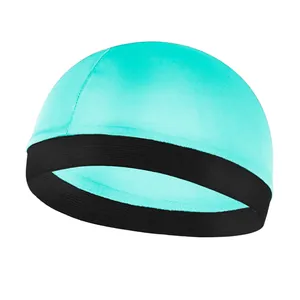 Detail of the turquoise wave dome cap with a wide black elastic band and flat seams