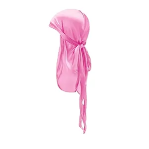 Detailed view of glossy pink satin silky durag for children with long tail ties