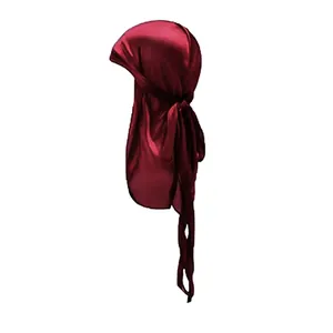 Detailed close-up of shiny dark red silky satin durag fabric and long tail straps