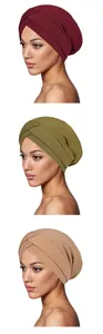 Detailed view of ribbed knit turbans with cross forehead design in various colors