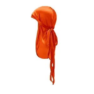 Detail of glossy orange silky durag for kids featuring long straps and smooth satin texture