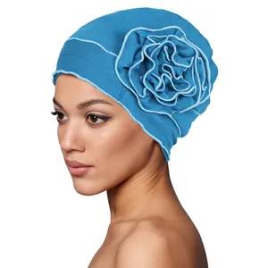 Detail of blue turban hat with large 3D flower and light blue contrast edging for women