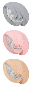Detail showing elastic edge stitching and soft satin lining of the double-layer sleep bonnet