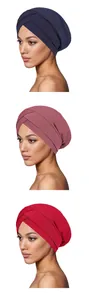 Close-up of three turban hats showing ribbed knit texture and front cross pleat design