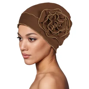 Detail of the oversized dark brown fabric flower with contrast edge stitching on the turban