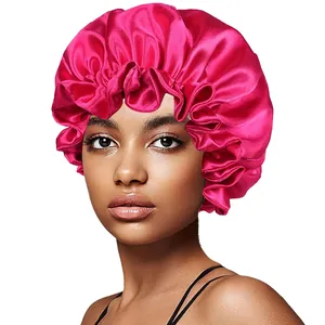 Close-up of a vibrant deep pink satin sleep cap featuring double-layered ruffled edges