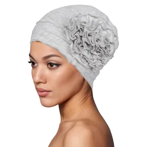 Detail of grey turban hat featuring a large 3D fabric flower and soft knit texture