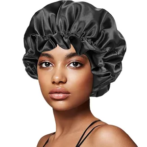 Detail of black silk satin bonnet with elastic ruffled edge shown on model for hair care