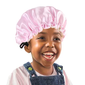 Detailed view of pink satin hair bonnet with adjustable black elastic button buckle