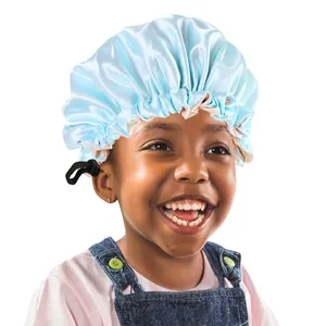 Detail view of light blue satin sleep cap for kids featuring an adjustable black buckle