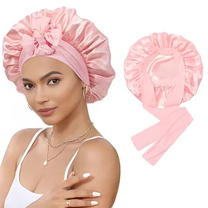 Détail du bonnet de nuit en satin rose avec large bande élastique et longs rubans ajustables