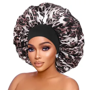 Detailed close-up of large leopard print satin sleep bonnet with a wide elastic black band