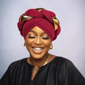 Detailed texture of burgundy turban with golden braid and striped fabric material