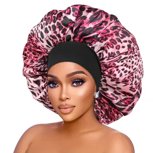 Detail of pink leopard print satin bonnet with wide black elastic headband for hair protection