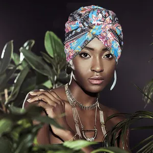 Ethnic turban hat with vibrant floral print and bohemian necklaces on fashion model