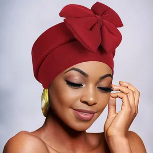 Detailed close-up of the large bow design and knit texture on the burgundy fashion turban