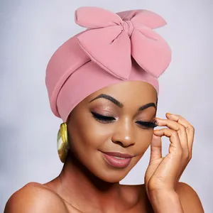 Close-up of pink turban headwrap with large bow knot and soft elastic fabric texture