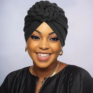 Close-up of black twisted turban hat with large layered floral knot decoration