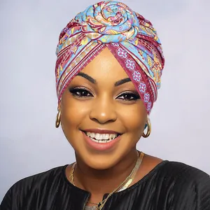 Close-up of floral knotted turban featuring ethnic geometric patterns in vibrant colors