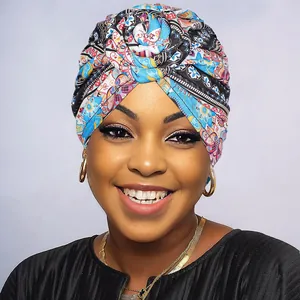 Close-up of a bohemian turban hat featuring intricate blue and orange floral prints