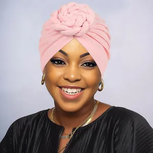 Close-up of pink twisted floral turban showing the detailed braided flower texture