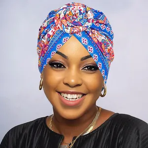 Detail of vibrant paisley floral turban with intricate twisted flower knot design