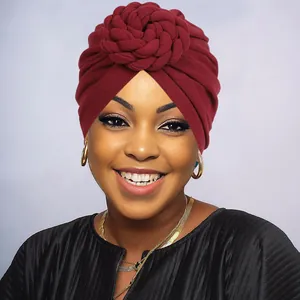 Close-up of a burgundy knit turban hat with a spiral braided flower knot for women